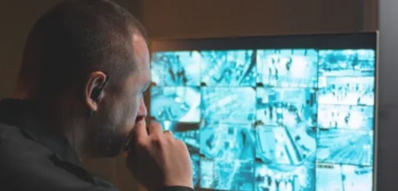 Security officer monitoring CCTV screens for a commercial property