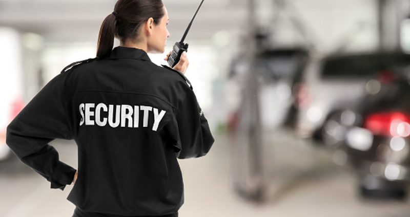 Uniformed security guard patrolling a residential parking area