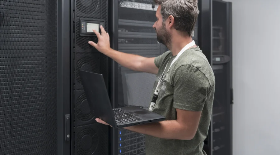 data-center-engineer-using-laptop-computer-server-room-specialist-facility-with-male-system-administ